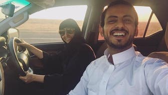 Young Saudi man takes selfie with his mother driving