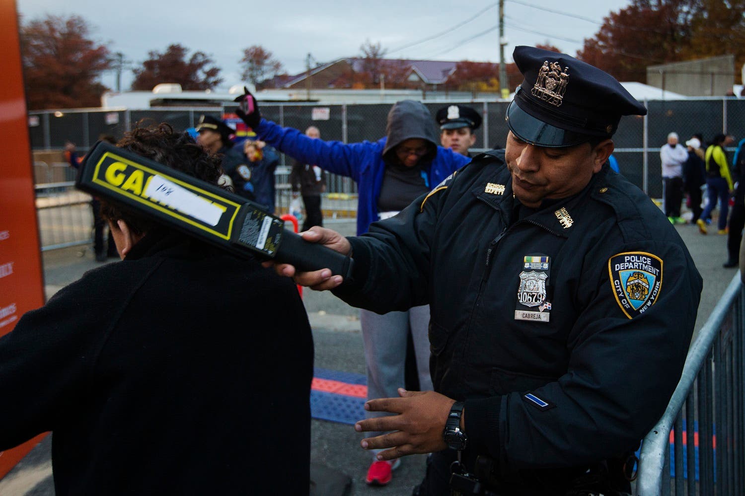 New York Police Department officers perform a security sweep on runners arriving to take part in the New York City Marathon. (Reuters)