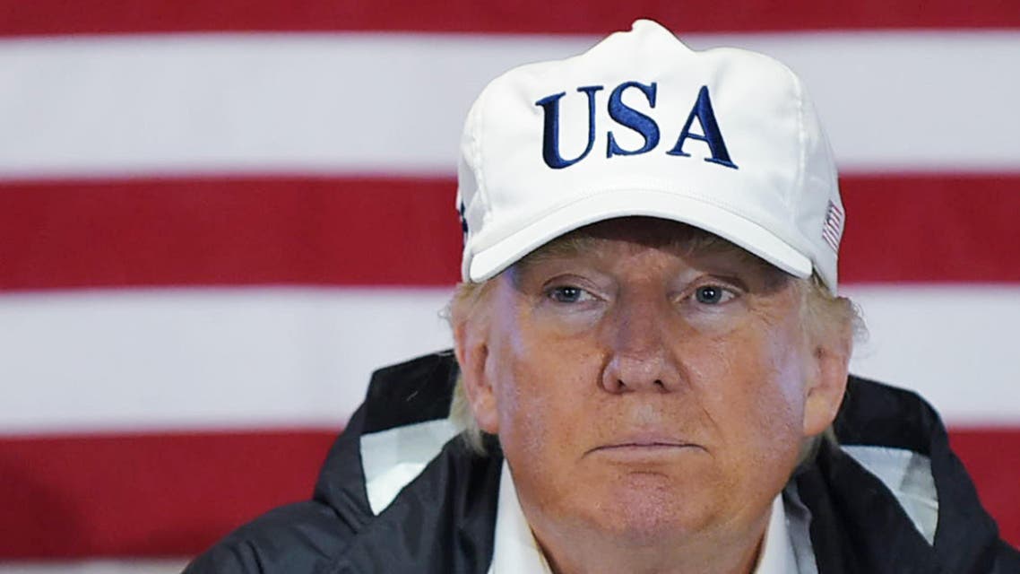 US President Donald Trump attends a briefing with senior military personnel, Puerto Rico Governor Ricardo Rossello, and US Virgin Islands Governor Kenneth Mapp in the Ward Room aboard the USS Kearsarge, off Puerto Rico on October 3, 2017. Nearly two weeks after Hurricane Maria thrashed through the US territory, much of the islands remains short of food and without access to power or drinking water. MANDEL NGAN / AFP