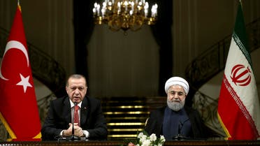 Turkish President Recep Tayyip Erdogan, left, speaks with media during a joint press conference with Iranian President Hassan Rouhani after their meeting at the Saadabad Palace in Tehran, Iran, Wednesday, Oct. 4, 2017. AP