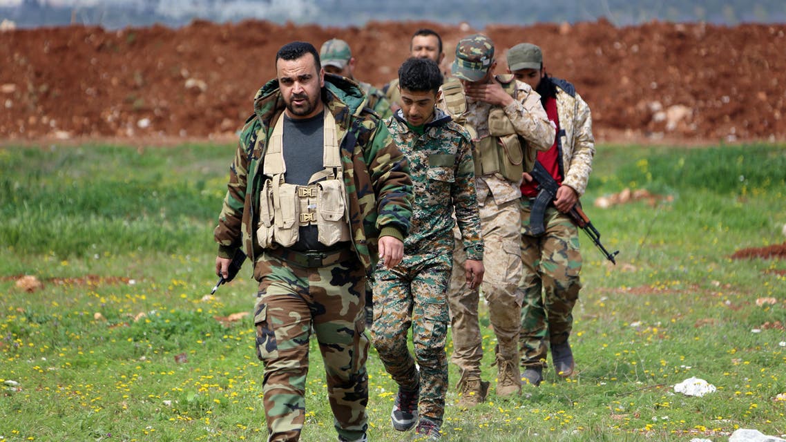 Members of the Syrian government forces march near the town of Qumhanah in the countryside of the central province of Hama, on April 1, 2017. (AFP)