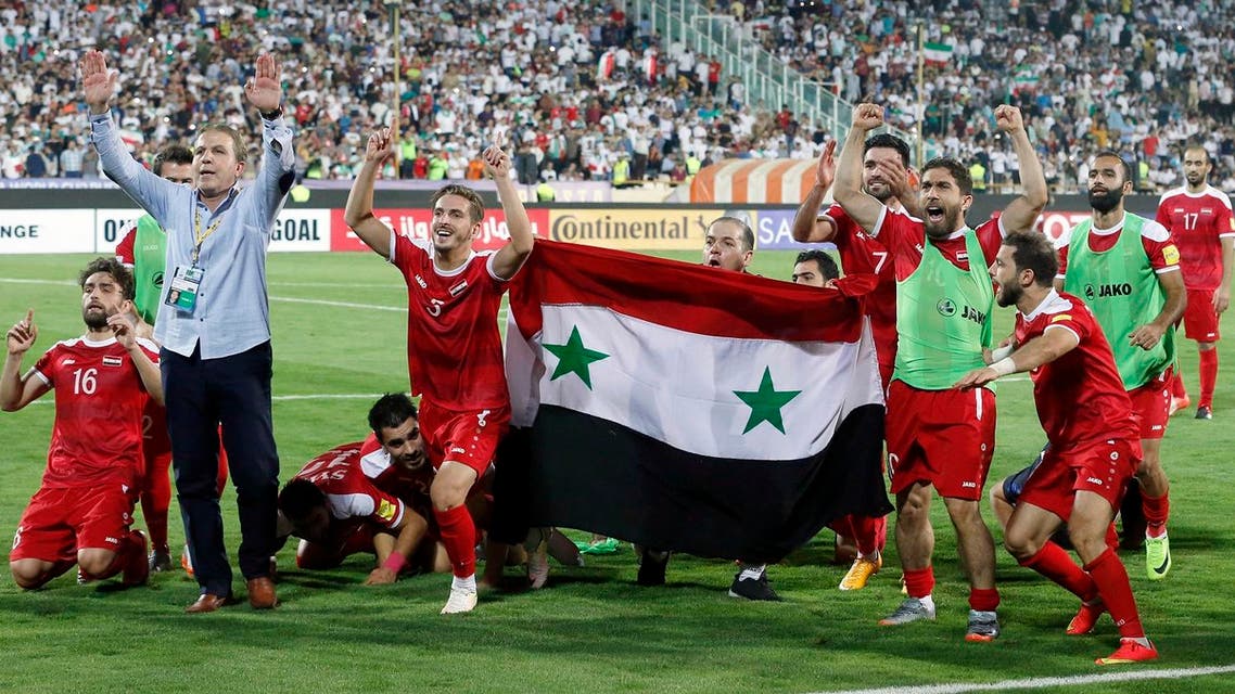 Syria's players celebrate at the end of their FIFA World Cup 2018 qualification football match against Iran at the Azadi Stadium in Tehran on September 5, 2017. (AFP)