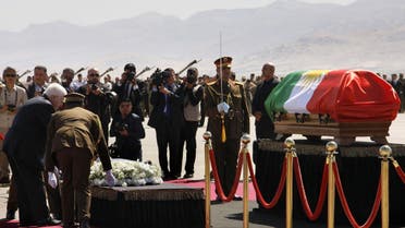 Iraqi President Fuad Massum (left) lays a wreath next to Iraqi ex-president Jalal Talabani’s coffin during a ceremony at the airport in the Iraqi Kurdish city of Sulaimaniyah on October 6, 2017. (AFP)