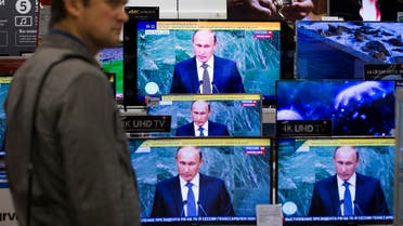 A man looks at television screens in an electronics shop as Russian President President Vladimir Putin addresses the 70th session of the United Nations General Assembly, Moscow, Russia, Monday, Sept. 28, 2015. (AP)