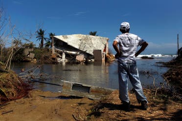 A man surveys a house that was washed away by heavy surf during the passing of Hurricane Maria in Manati, Puerto Rico, on October 6, 2017. (AFP)