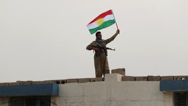 An Iranian Kurdish Peshmerga member of the Kurdistan Democratic Party of Iran (KDP-Iran) holds a Kurdish flag as he takes part in a gathering to urge people to vote in the upcoming independence referendum in the town of Bahirka, north of Arbil, the capital of the autonomous Kurdish region of northern Iraq, on September 21, 2017. The controversial referendum on independence for Iraqi Kurdistan is set for September 25. SAFIN HAMED / AFP
