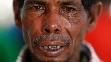Lalu Miya cries over the bodies of his wife and children, who died after a boat with Rohingya refugees capsized as they were fleeing Myanmar, before the funeral just behind Inani Beach near Cox's Bazar, Bangladesh. (Reuters)