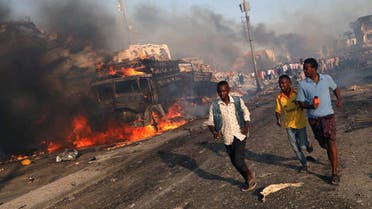 Civilians evacuate from the scene of an explosion in KM4 street in the Hodan district of Mogadishu, Somalia. (Reuters)
