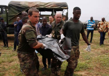 French soldiers and rescuers carry a body after a propeller-engine cargo plane crashed in the sea near the international airport in Ivory Coast’s main city, Abidjan. (Reuters)