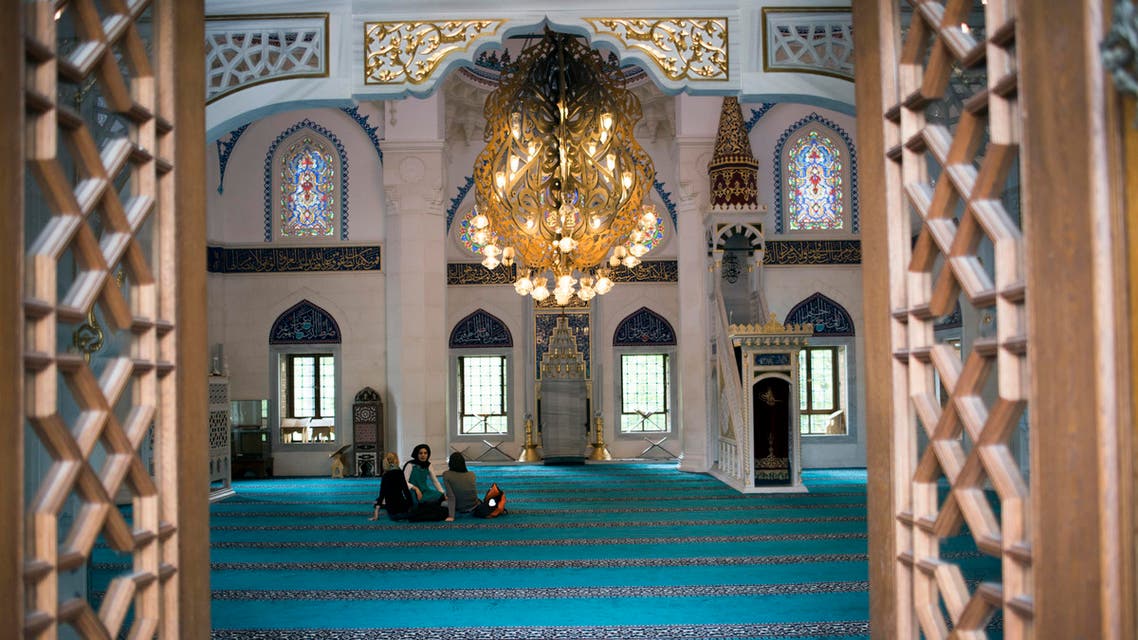 Three women talk inside the mosque during the opening of an info center for the prevention of Islamic extremism at Sehitlik mosque in Berlin. (Reuters)