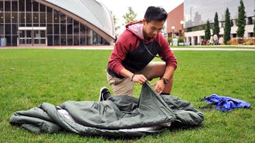  Vick Liu unrolls his TravlerPack, a lightweight sleeping bag, outside the Kresge Auditorium at the Massachusetts Institute of Technology in Cambridge, Mass. (AP)