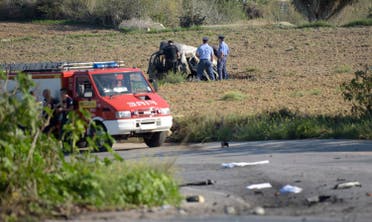 Police inspect the wreckage of a car bomb believed to have killed journalist and blogger Daphne Caruana Galizia close to her home in Bidnija, Malta? on October 16, 2017. The force of the blast broke her car into several pieces and catapulted the journalist's body into a nearby field, witnesses said. She leaves a husband and three sons. Caruana Galizia's death comes four months after Prime Minister Joseph Muscat's Labour Party won a resounding victory in a general election he called early as a result of scandals to which Caruana Galizia's allegations were central. (AFP)