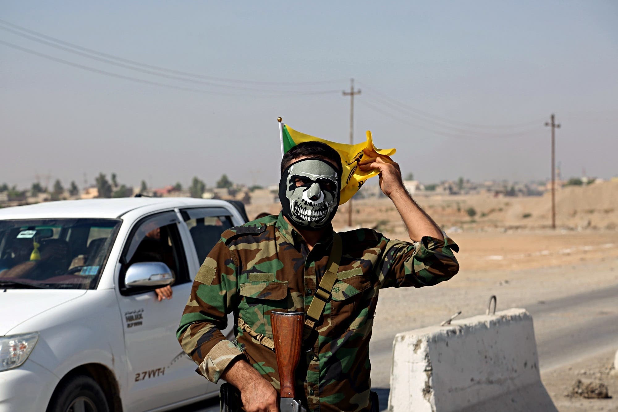 A fighter with Popular Mobilization Forces stands guard in Tuz Khormato, that was evacuated by Kurdish security forces, 210 km north of Baghdad, on Oct. 16, 2017. (AP)