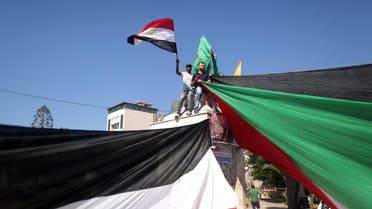 Palestinians wave the flags of Egypt and Palestine as they gather in Gaza City to celebrate after rival Palestinian factions Hamas and Fatah reached an agreement on ending a decade-long split following talks mediated by Egypt on October 12, 2017. Details of the agreement have not yet been released and a press conference was being planned in the Egyptian capital. (AFP)