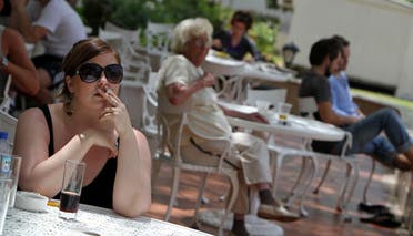 A passenger stranded in Dubai smokes a cigarette at a hotel in the Gulf emirate on April 19, 2010. (AFP)