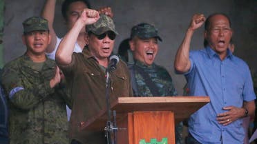 President Rodrigo Duterte cheers as he declares the liberation of Marawi city in southern Philippines after almost five months of the siege by pro-ISIS. (AP)