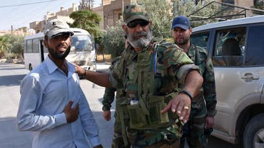 Issam Zahreddine (R) Major General of the Syrian Republican Guard, talks with a civilian in the eastern city of Deir Ezzor on September 10, 2017, as they continue to press forward with Russian air cover in the offensive against Islamic State group jihadists across the province. (AFP)