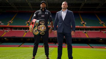Britain's Anthony Joshua (L) and Bulgaria's Kubrat Pulev (R) stand on the pitch at the Principality Stadium in Cardiff on September 11, 2017 during a promotional event for their heavyweight world title boxing match. Britain's Anthony Joshua will defend his IBO, IBF and WBA world heavyweight titles against Bulgaria's Kubrat Pulev at Cardiff's Principality Stadium on October 28. (AFP)