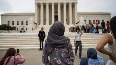 A woman wearing a hijab stands outside the US Supreme Court, October 11, 2017. (AFP)