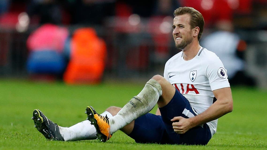 Tottenham Hotspur's English striker Harry Kane holds his leg after appearing to pick up an injury during the English Premier League football match between Tottenham Hotspur and Liverpool at Wembley Stadium in London, on October 22, 2017.