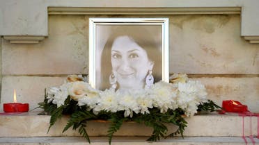 Flowers and tributes lay at the foot of the Great Siege monument in Valletta, Malta, on October 19, 2017 which has been turned into a temporary shrine for Maltese journalist and blogger Daphne Caruana Galizia (picture) who was killed by a car bomb outside her home in Bidnjia, Malta, on October 16, 2017. (AFP)
