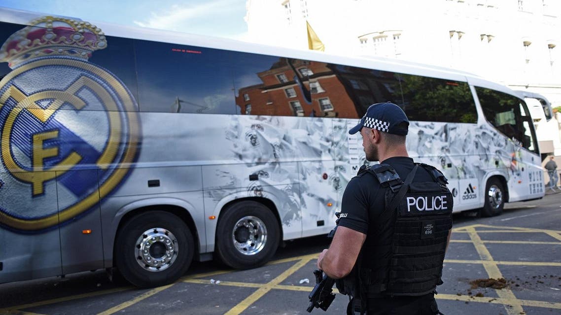 An armed police officer stands on duty as Real Madrid's team bus arrives at the stadium ahead of the UEFA Champions League final football match between Juventus and Real Madrid in Cardiff, south Wales, on June 3, 2017. (AFP)