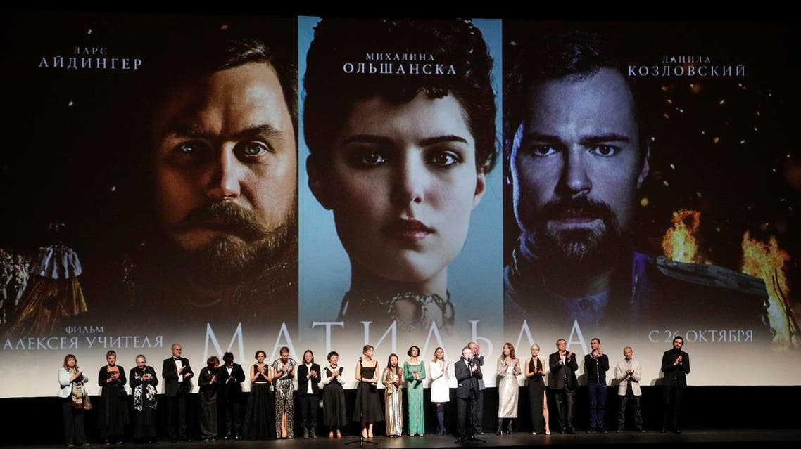 Alexei Uchitel, Russian film director of "Matilda," a movie about the last Russian czar's affair with a ballerina and his movie crew applaud at the stage at the Mariinsky Theatre in Moscow, Russia, Monday, Oct. 23, 2017. "Matilda" loosely tells the story of Nicholas II's infatuation with prima ballerina Matilda Kshesinskaya angered hard-line nationalists and some Orthodox believers in Russia, who see it as blasphemy against the emperor, glorified as a saint by the Russian Orthodox Church. (AP Photo/Dmitri Lovetsky)