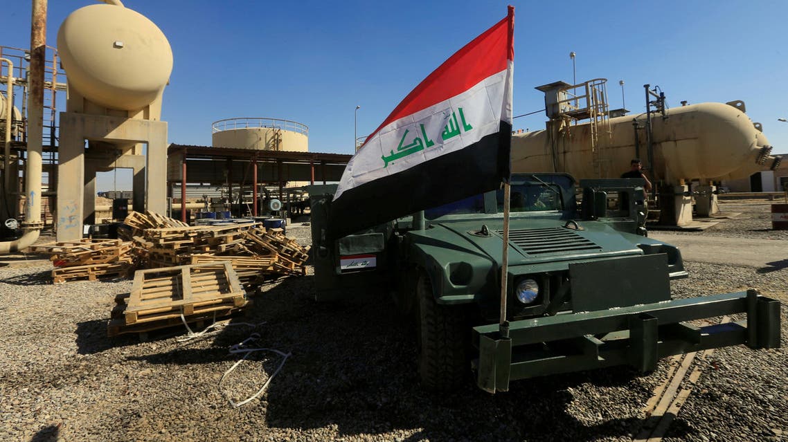 FILE PHOTO: An Iraqi flag is seen on a military vehicle at an oil field in Dibis area on the outskirts of Kirkuk, Iraq October 17, 2017. REUTERS/Alaa Al-Marjani/File Photo