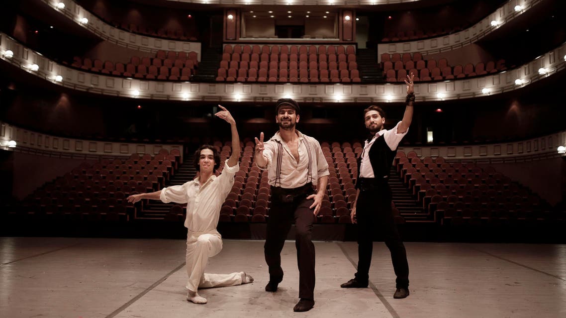 In this March 30, 2017 photo, Egyptian longtime friends and ballet co-stars Ahmed Nabil, left, Hani Hassan, center, and Mohammed Hamed, pose on stage after a performance of "Zorba," at the Cairo Opera House, in Egypt. AP
