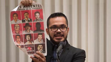 Marcos Vizcarra, a journalist for the Mexican publication Noroeste, holds up a poster with missing Mexican journalists as he speaks after receiving the 2017 Peter Mackler Award at the National Press Club in Washington, DC, October 26, 2017. (AFP)