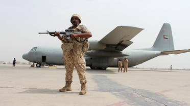 A soldier from the United Arab Emirates stands guard next to a UAE military plane at the airport of Yemen's southern port city of Aden August 8, 2015. Soldiers from the United Arab Emirates, at the head of a Gulf Arab coalition fighting Iran-allied Houthi forces in Yemen, are preparing for a long, tough ground war from their base in the southern port of Aden. Picture taken August 8, 2015. REUTERS/Nasser Awad TPX IMAGES OF THE DAY