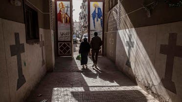 Coptic Christians walk outside St. Markos Church in Minya, south of Cairo, Egypt, where two policemen guarding the church were shot dead by unknown gunmen on the early hours of Tuesday, Jan. 6,. 2015, a day before Egypt's Coptic Christmas falls. (AP)