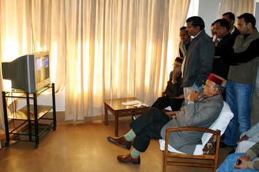 Bharatiya Janata Party (BJP) leader and Chief Minister of Himachal Pradesh state Prem Kumar Dhumal, front seated, watches election results on a television at Hamirpur, about 90 kilometers (56 miles) from Dharmsala, India, Thursday, Dec. 20, 2012. (File photo: AP)