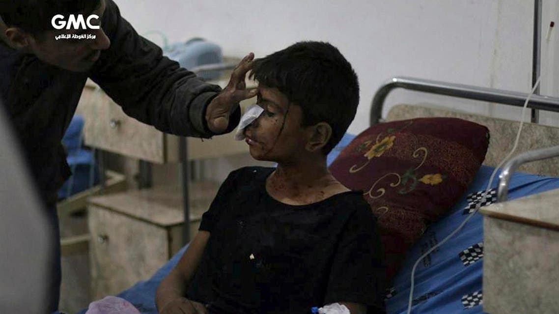 In this photo provided by the Syrian anti-government activist group, Ghouta Media Center, GMC, which has been authenticated based on its contents and other AP reporting, shows an injured boy receiving treatment at a hospital in Ghouta, an opposition-controlled suburb of Damascus, Syria, Tuesday, Oct. 31, 2017. GMC said Tuesday that several children were killed when government shelling hit their school in Ghouta. (Ghouta Media Center via AP)