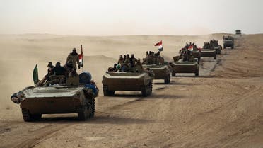 Iraqi forces and members of the Popular Mobilisation units advance toward al-Qaim on November 2, 2017. (AFP)