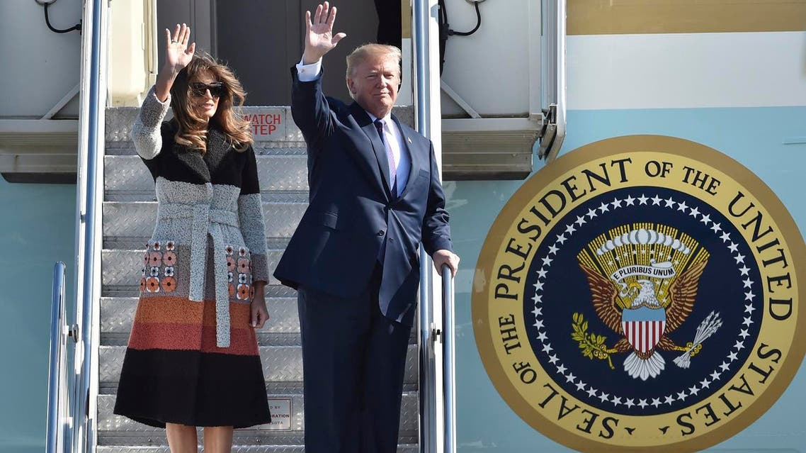 US President Donald Trump and first lady Melania Trump wave on their arrival at the US Yokota Air Base, on the outskirts of Tokyo, Sunday, Nov. 5, 2017. (AP)