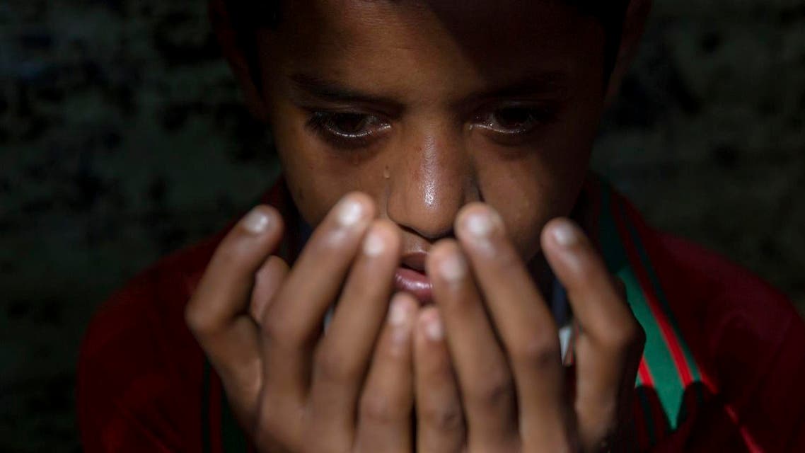 A young Rohingya Muslim boy, Sheikh Ahmad, center, recites verses from the Quran. AP
