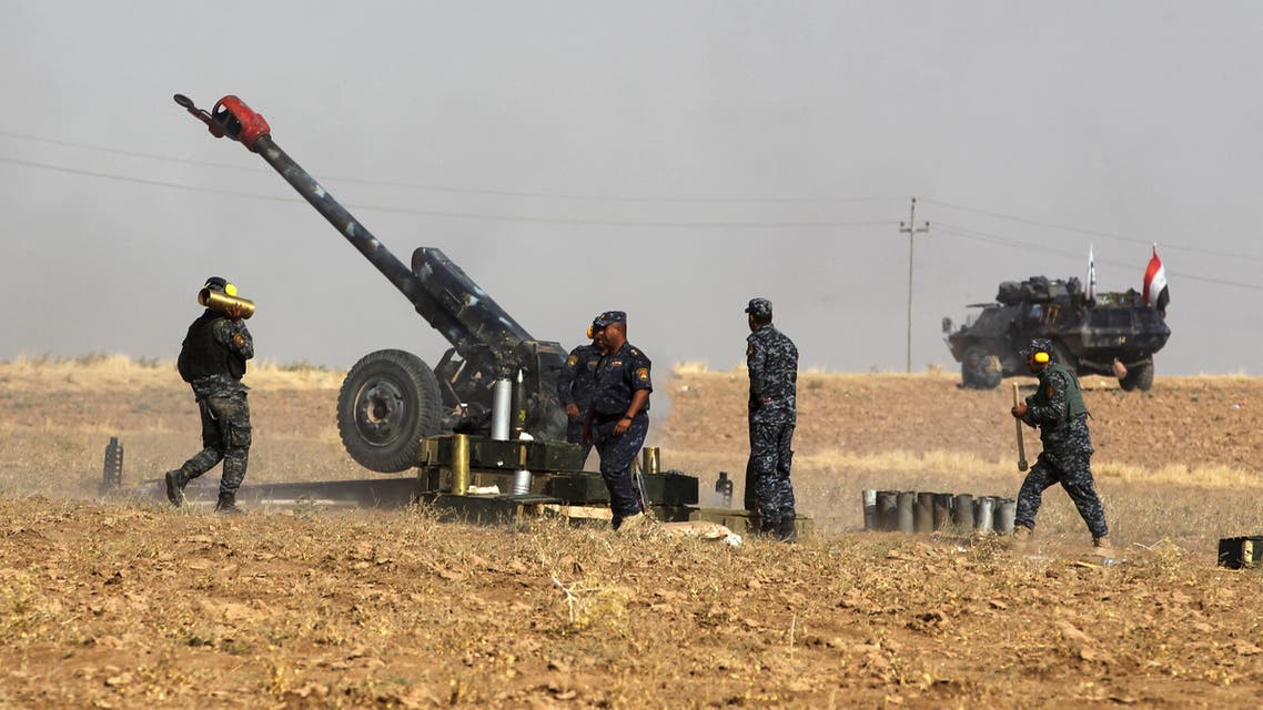 A picture taken on October 26, 2017 shows members of the Iraqi forces manning an artillery gun as they fire against Kurdish Peshmerga positions near the area of Faysh Khabur, located on the Turkish and Syrian borders in the Iraqi Kurdish autonomous region, on October 26, 2017. AHMAD AL-RUBAYE / AFP