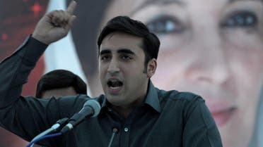 Bilawal Bhutto Zardari addresses supporters in front of a poster of slain prime minister Benazir Bhutto at a rally in Karachi on November 30, 2013. (AFP)