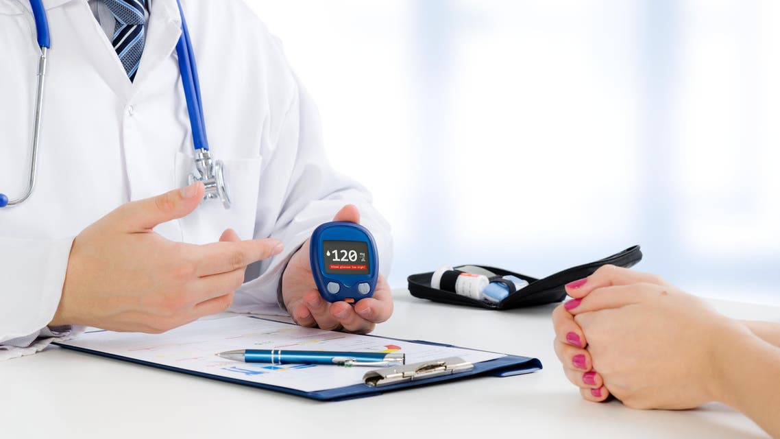 Doctor shows glucometer with glucose level - Stock image...