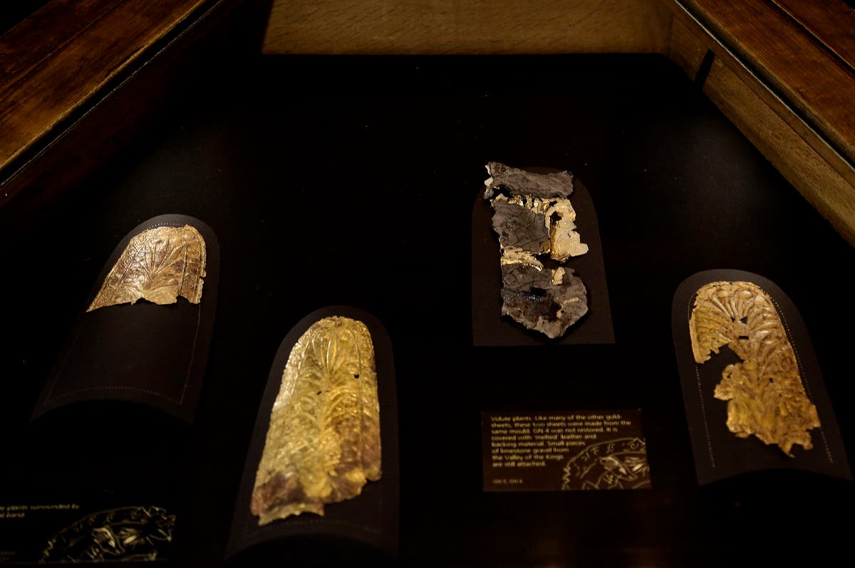 Ancient Egyptian gold artefacts, some restored and some left with small pieces of limestone gravel from the Valley of the Kings still attached, displayed in a glass case during the opening of the exhibition entitled Tutankhamun's Unseen Treasures marking the 115th anniversary of the Egyptian museum in Cairo, Egypt. (AP)