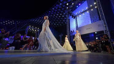 Models present creations by Amato during the Arab Fashion Week in Dubai on November 15, 2017. (AFP)