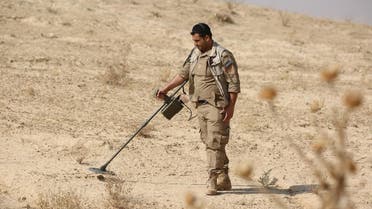 A Syrian member of the Roj mine clearing organization works at removing IEDs and mines planted by ISIS in Hassakeh province, on October 27, 2016. (AFP)