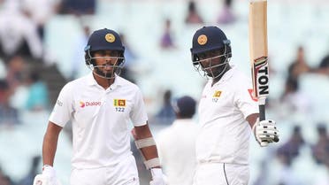 Sri Lanka’s Angelo Mathews celebrates after scoring a half-century (50 runs) as captain Dinesh Chandimal looks on during the third day of the first Test between India and Sri Lanka at the Eden Gardens cricket stadium in Kolkata on November 18, 2017. (AFP)