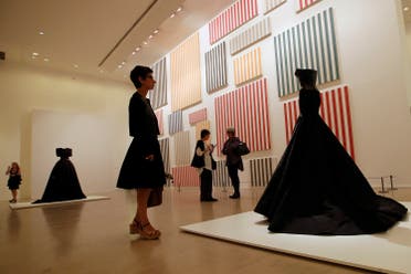 A visitor looks at “Bustier crocodile” of Haute Couture Spring Summer 2003 collections by French Tunisian born Fashion designer Azzedine Alaia, presented for the first Paris retrospective of couturier at Museum of Modern Art in Paris, on Sept. 25, 2013. (AP)