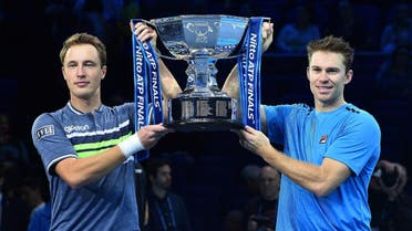Finland's Henri Kontinen and Australia's John Peers hold the winner's trophy after winning their men's doubles final match against Brazil's Marcelo Melo and Poland's Lukasz Kubot on day eight of the ATP World Tour Finals tennis tournament at the O2 Arena in London on November 19, 2017. Kontinen and Peers won 6-4, 6-2. AFP