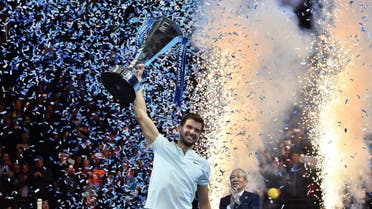 Bulgaria's Grigor Dimitrov holds the trophy as he celebrates winning his men's singles final match against Belgium's David Goffin on day eight of the ATP World Tour Finals tennis tournament at the O2 Arena in London on November 19, 2017. Dimitrov won the match 7-5, 6-4, 6-3. Glyn KIRK / AFP