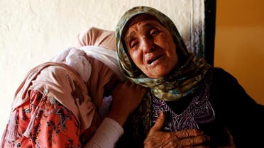 Relatives mourn the death of Lakbira Essabiry, one of the people who were killed when a stampede broke out in the southwestern Moroccan town of Sidi Boulaalam as food aid was being distributed in a market, in Sidi Boullaalam. (Reuters)