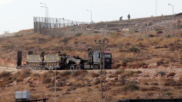 A picture taken on October 11, 2017, from the Syrian village of Atme in the northwestern province of Idlib shows Turkish military vehicles driving around a military base on the Turkish side of the border with Syria. Turkey-backed Syrian rebels are preparing for an operation to oust jihadists from the northwestern province of Idlib. Early this week, Turkey's army said it had launched a reconnaissance mission in Idlib days after President Recep Tayyip Erdogan announced an incursion to oust Al-Qaeda's former Syrian affiliate from the area.  Omar haj kadour / AFP