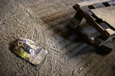 A religious picture remains on the ground on August 27, 2013 in the central Egyptian city of Minya inside Amba Moussa Coptic church that was vandalized and torched by unknown assailants. (AFP)